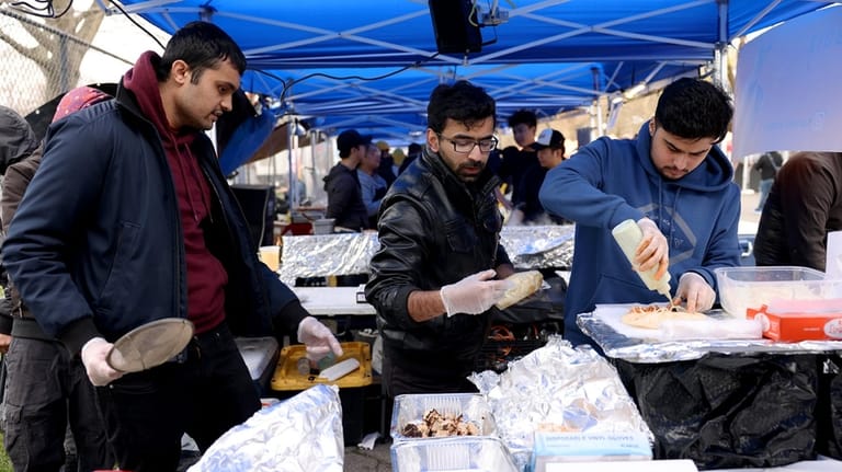 Karachi Kabob Boiz prepares rolls at the Queens Night Market...