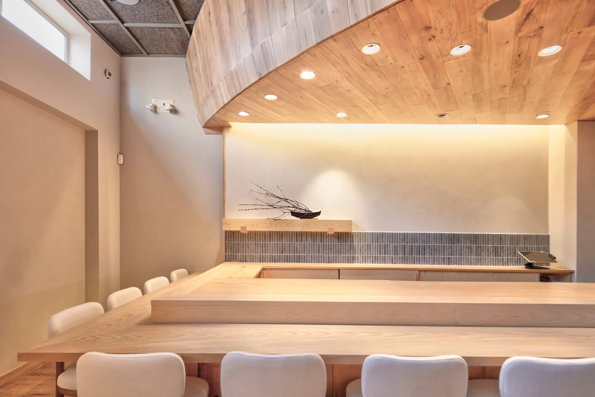 A blond wood sushi counter