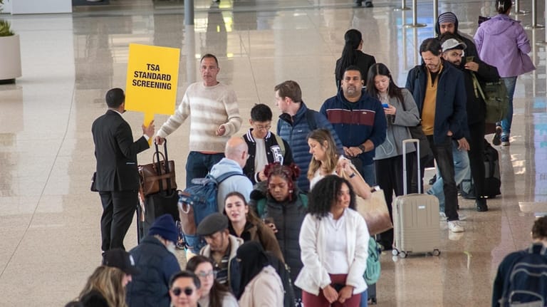 Passengers line up to wait for security clearance at Terminal...