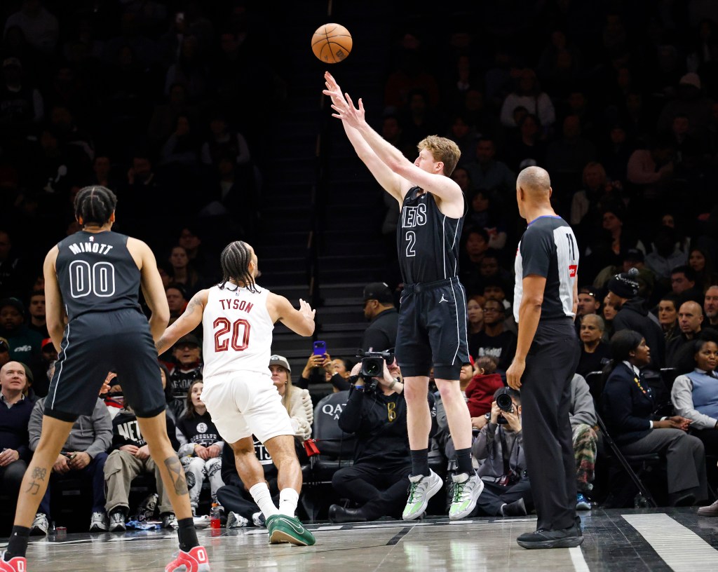 Danny Wolf of the Brooklyn Nets shoots over Jaylon Tyson of the Cleveland Cavaliers.