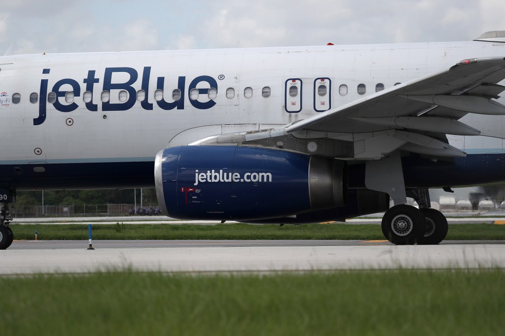 A JetBlue plane on the tarmac prepares for takeoff.
