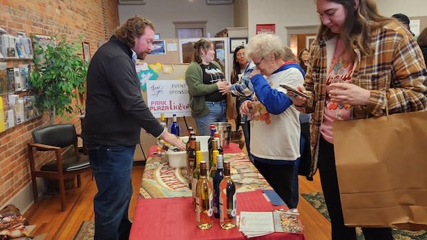 People sample wine from a vendor at the Wellsville Wine Walk