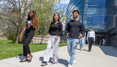 Binghamton University School of Management students outside the Academic A building on campus.