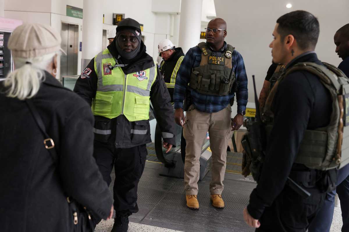 ICE agents at JFK Airport speaking with passengers
