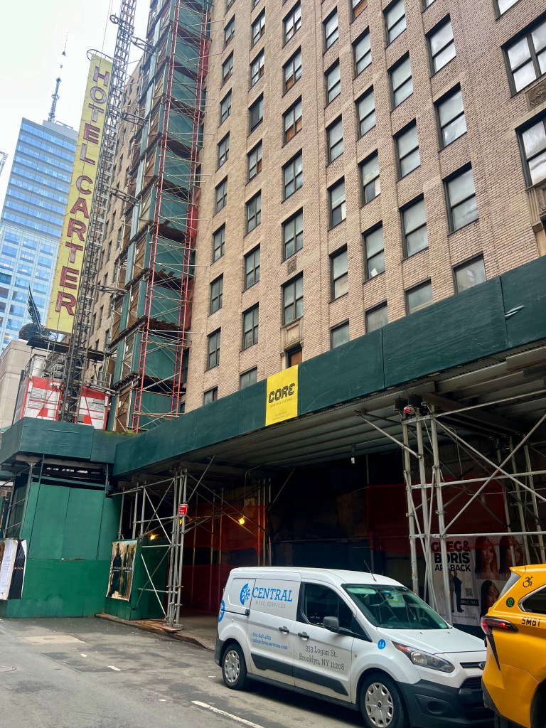 The Hotel Carter building, under scaffolding and renovation, with a white "Central HVAC Services" van parked outside.