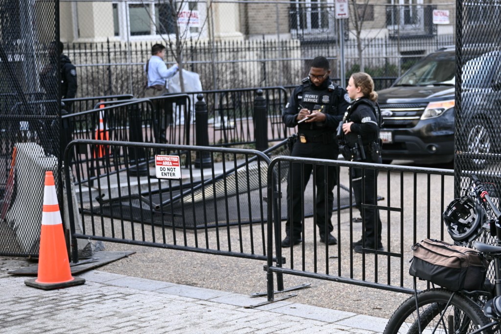Secret Service members monitor the scene after a vehicle smashed through a security barricade near the White House.