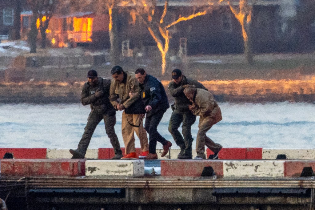 Former Venezuelan President Nicolás Maduro and his wife Cilia in prison garb being transferred by DEA agents.