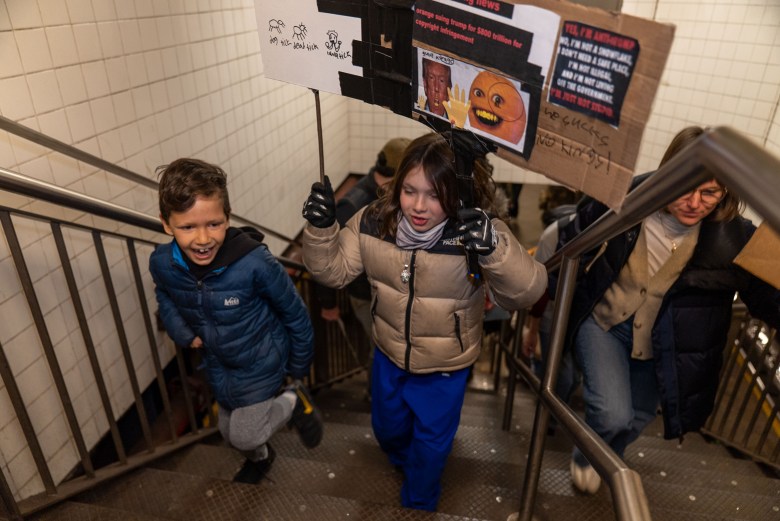 A family of protesters leaves the subway station at 59th Street for the No Kings NYC event in Manhattan on Saturday, March 28, 2026. Photo by Allison Hunter for The Haitian Times.
