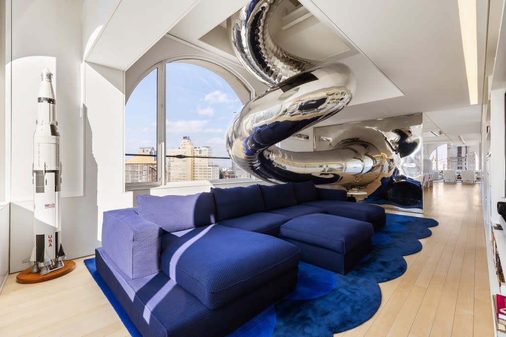 The home is drawing attention for its most unusual feature: a four-story stainless-steel spiral slide that runs through the apartment. Shannon Dupre of DD-Reps