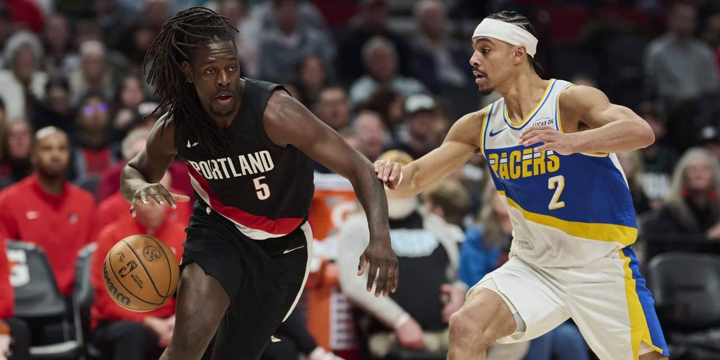 A photo of Jrue Holiday dribbling against Andrew Nembhard for the Indiana Pacers.