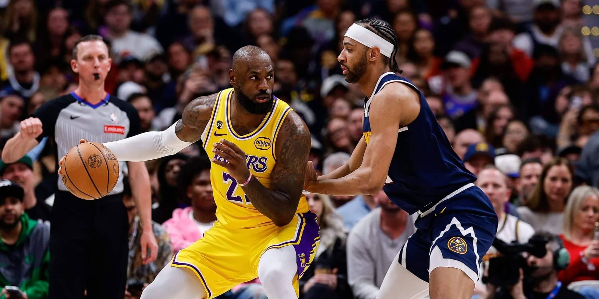 A photo of LeBron James dribbling against the Denver Nuggets.