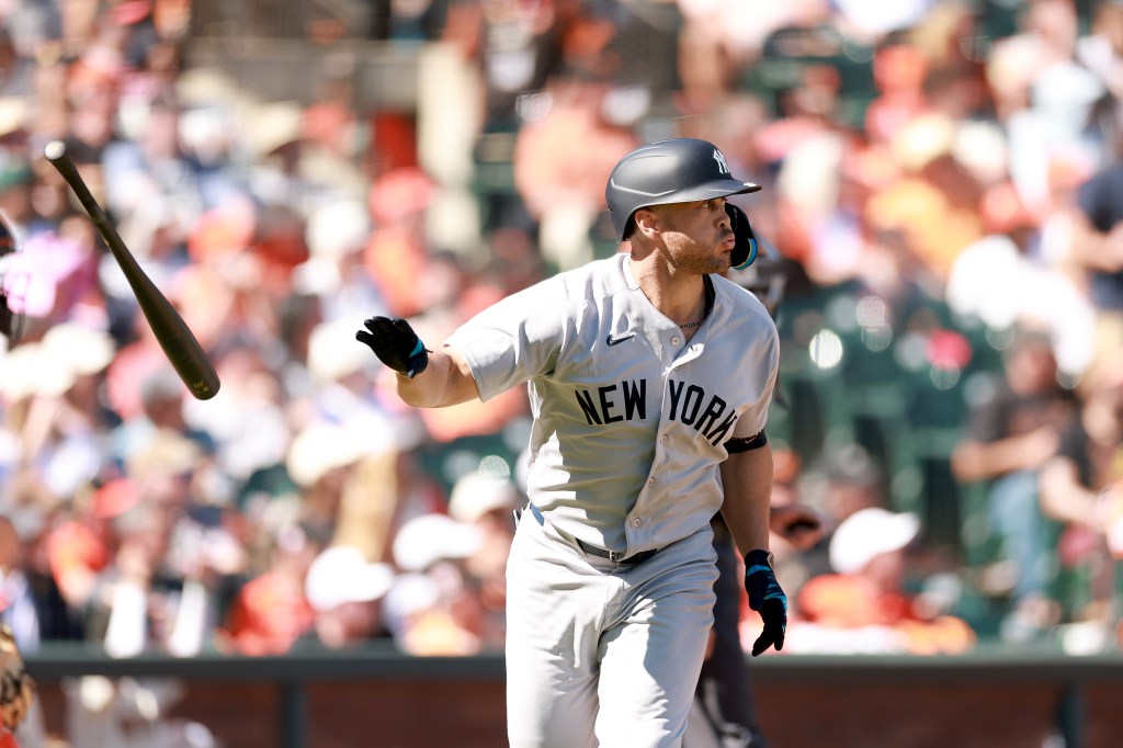 Giancarlo Stanton of the New York Yankees tosses his bat after hitting a home run.