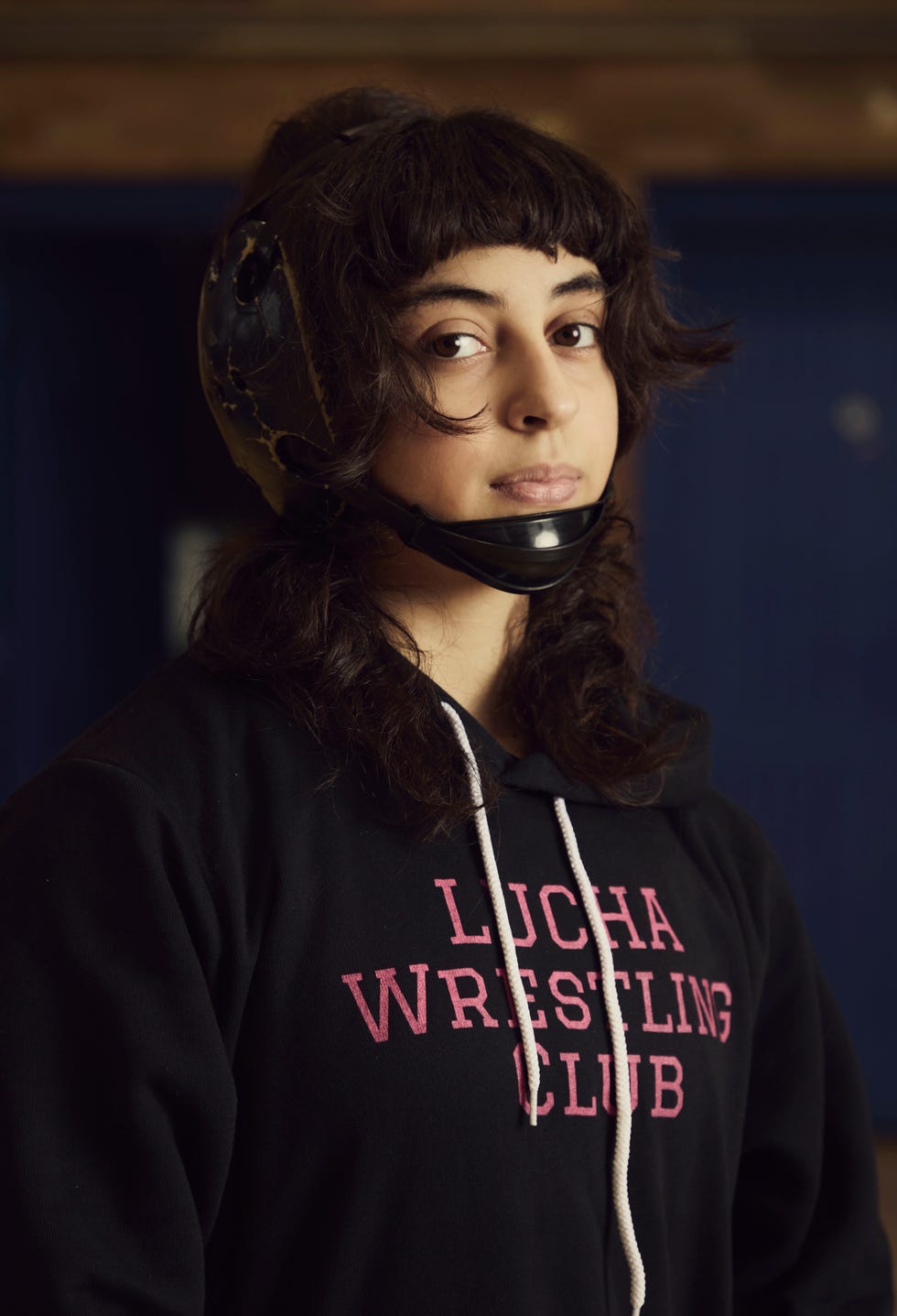 person wearing a wrestling hoodie and headgear