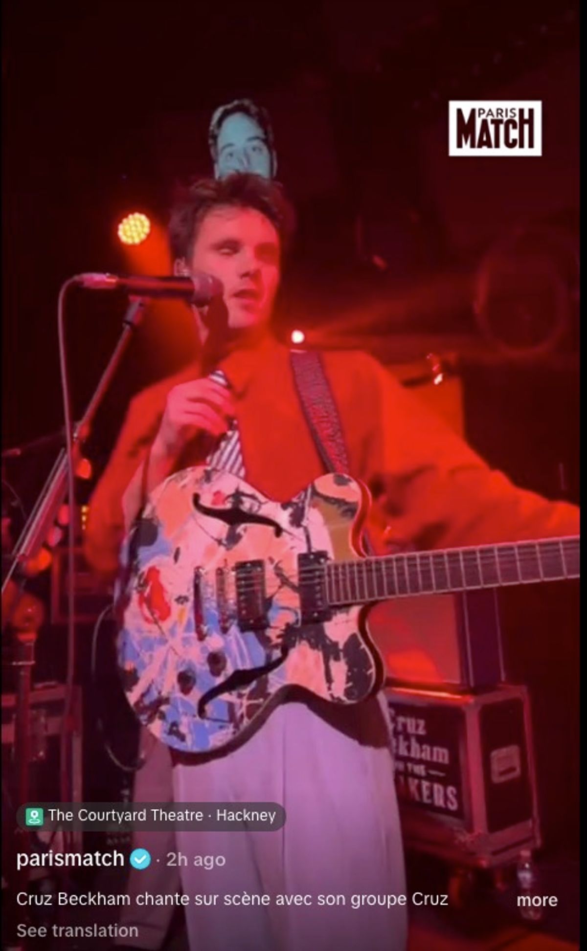 cruz playing guitar on stage