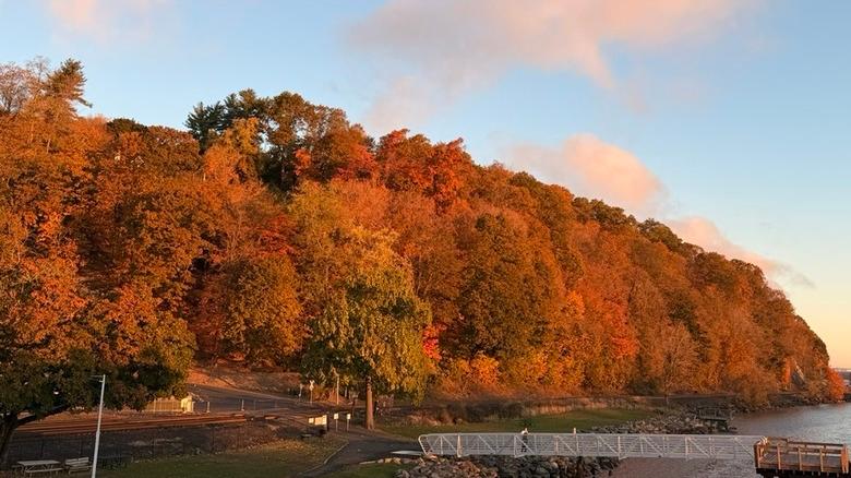 Milton Landing Park and pier on Hudson River surrounded by fall foliage in Hudson Valley, New York
