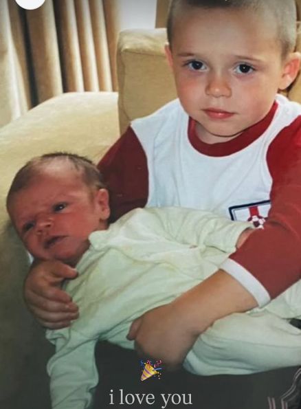 A young Brooklyn Beckham holding a baby Cruz Beckham