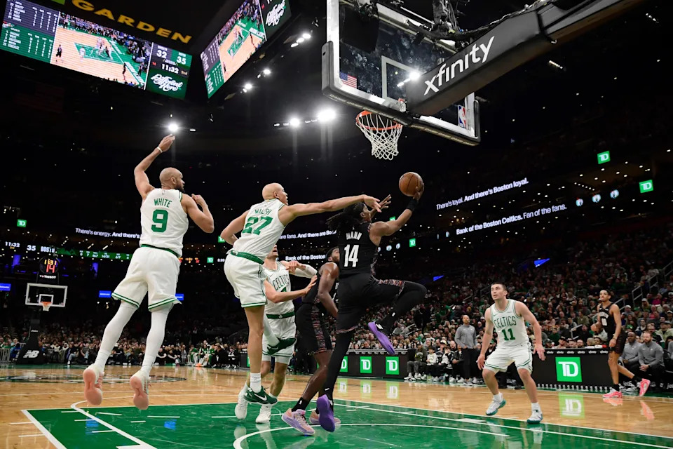 Feb 27, 2026; Boston, Massachusetts, USA; Brooklyn Nets guard Terance Mann (14) underhands the ball while Boston Celtics guard Jordan Walsh (27) defends during the first half at TD Garden. Mandatory Credit: Bob DeChiara-Imagn Images