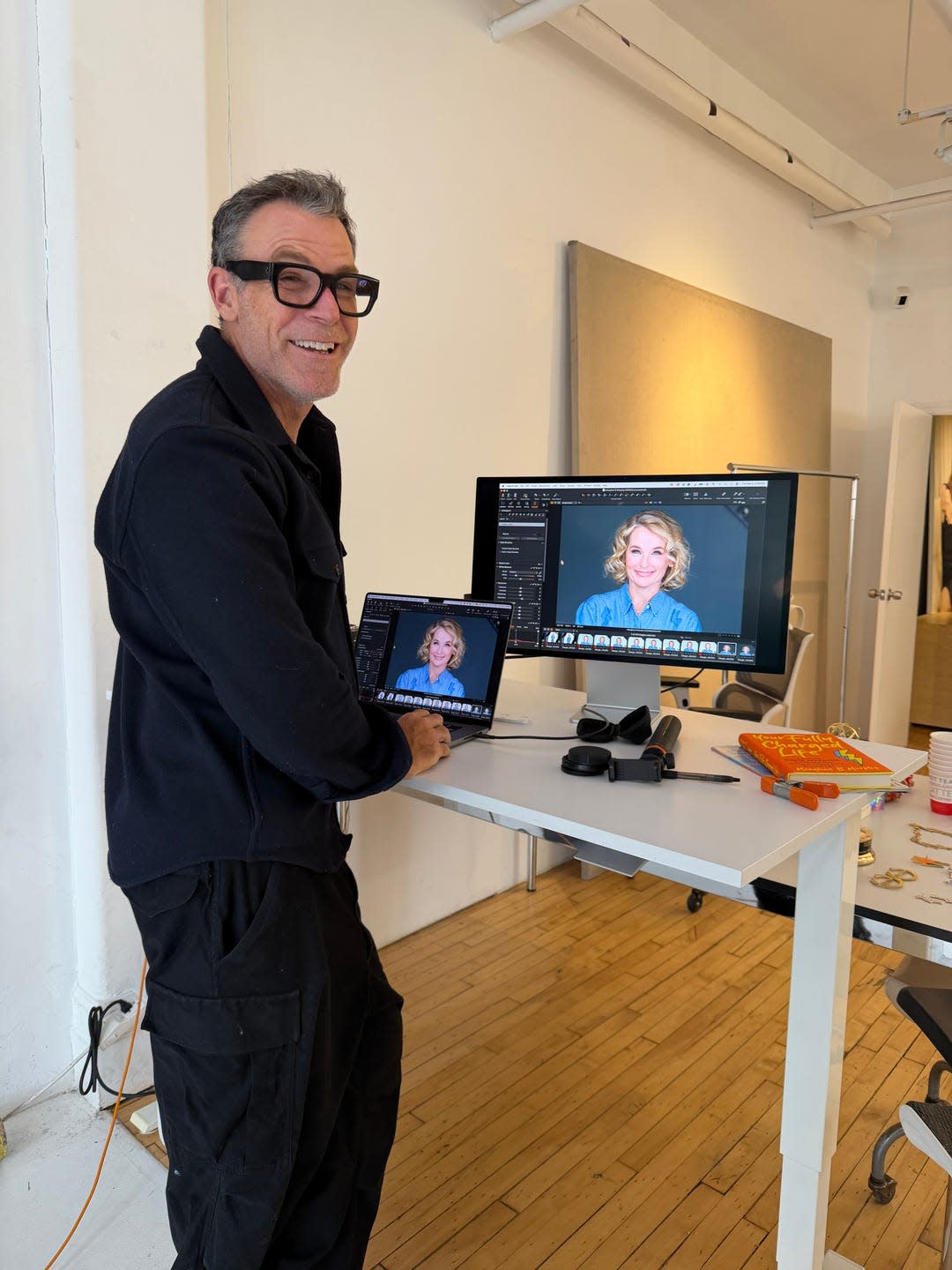 person using a laptop and desktop computer in a workspace