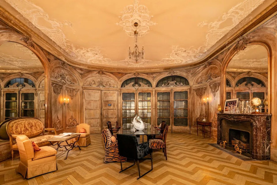 This view of the House of Cassini's dining room shows its stunning mirrors and the toll taken by time upon the carved wood paneling.