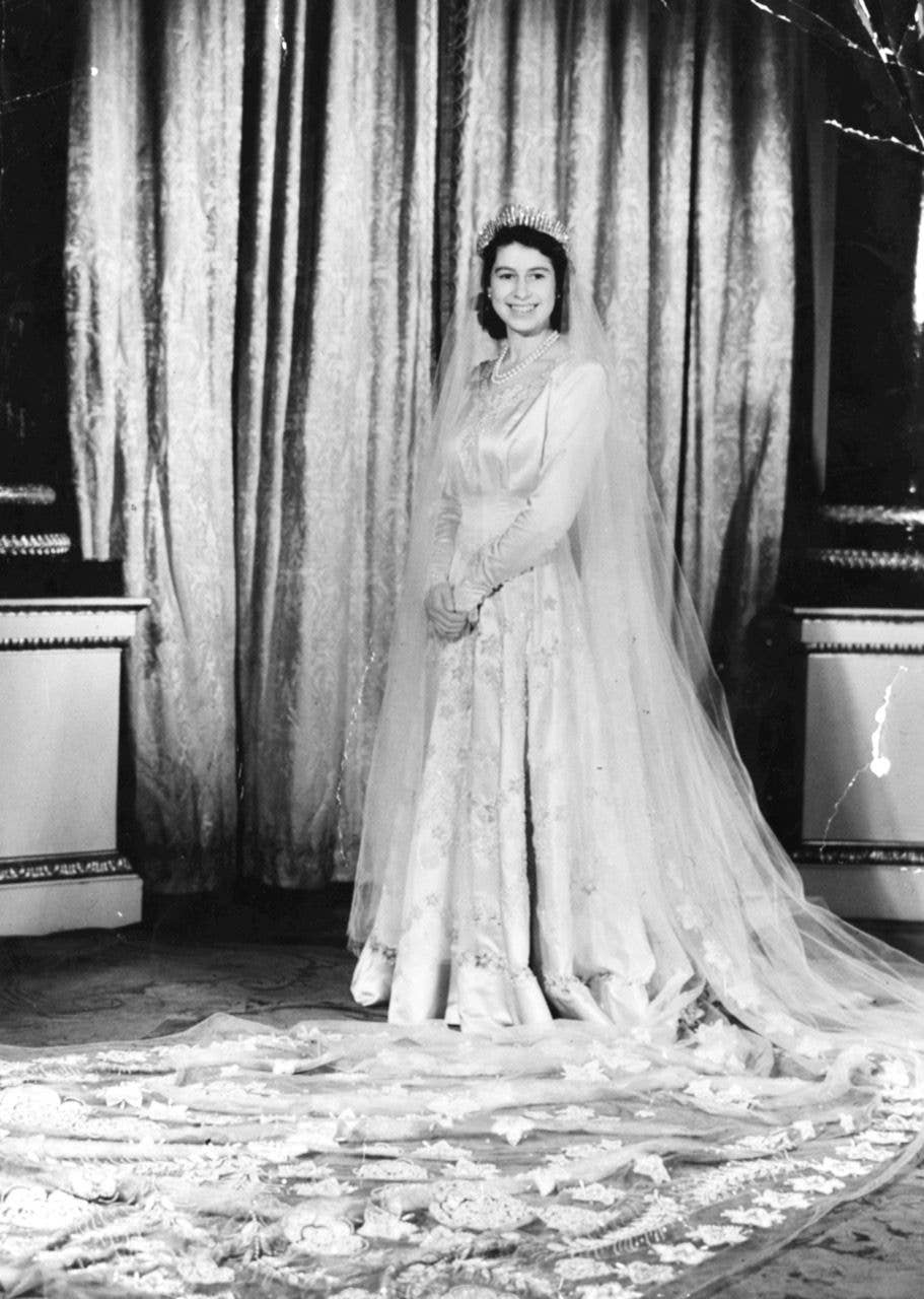 Princess Elizabeth wears her Norman Hartnell wedding dress with a long train embroidered with stars