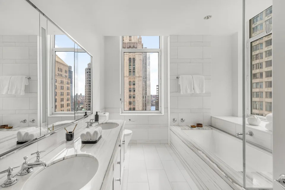 A bathroom with a tub in the Four Season Duplex in Manhattan New York