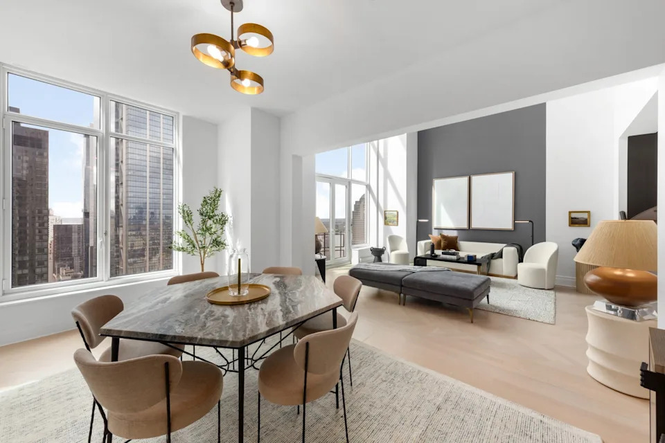 Living space and a dining table in the Four Season Duplex in Manhattan New York