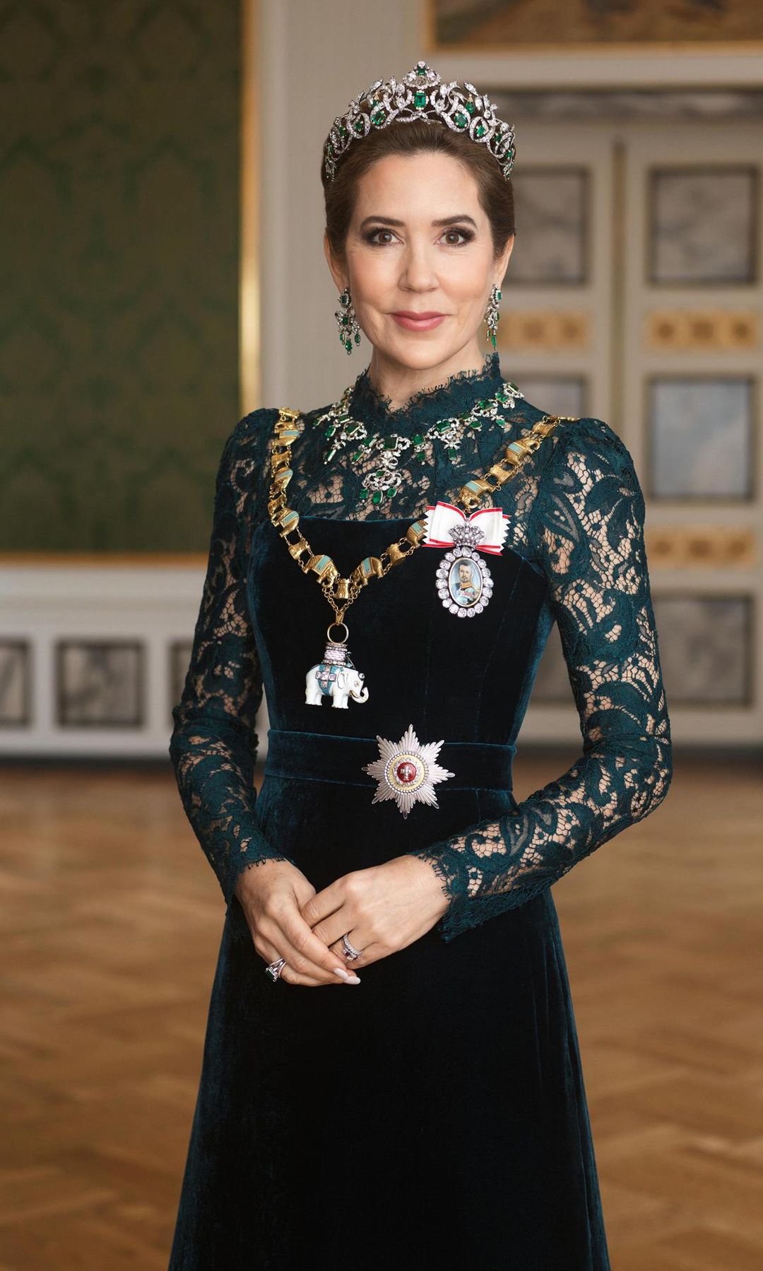 For the first time, Queen Mary wore the crown jewels. Per the Danish Royal House, the emerald set is "one of the four jewellery sets, or garnitures" that is at the disposal of the Queen of Denmark. The set was designed by the C.M. Weisshaupt and was a gift from Christian VIII to Queen Caroline Amalie. When the crown jewels are not in use, they are on display under Rosenborg Castle. Her Majesty was also photographed wearing the Order of the Elephant and a miniature portrait of her husband set in a gold frame with diamonds and "a bow of Order of Dannebrog ribbon."