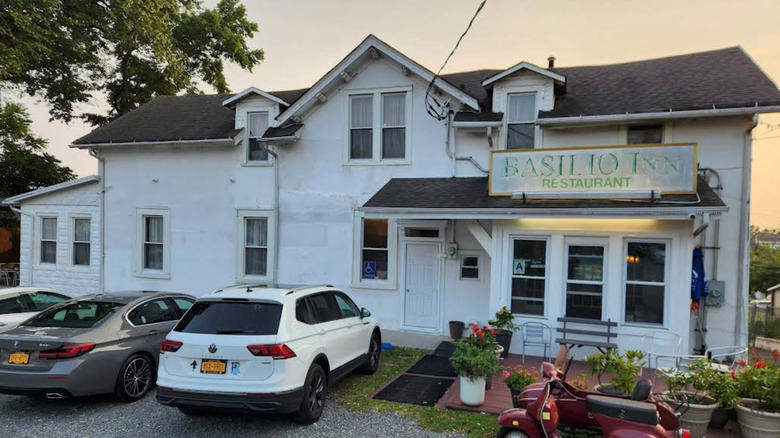 The exterior of Basilio Inn, featuring a faded sign