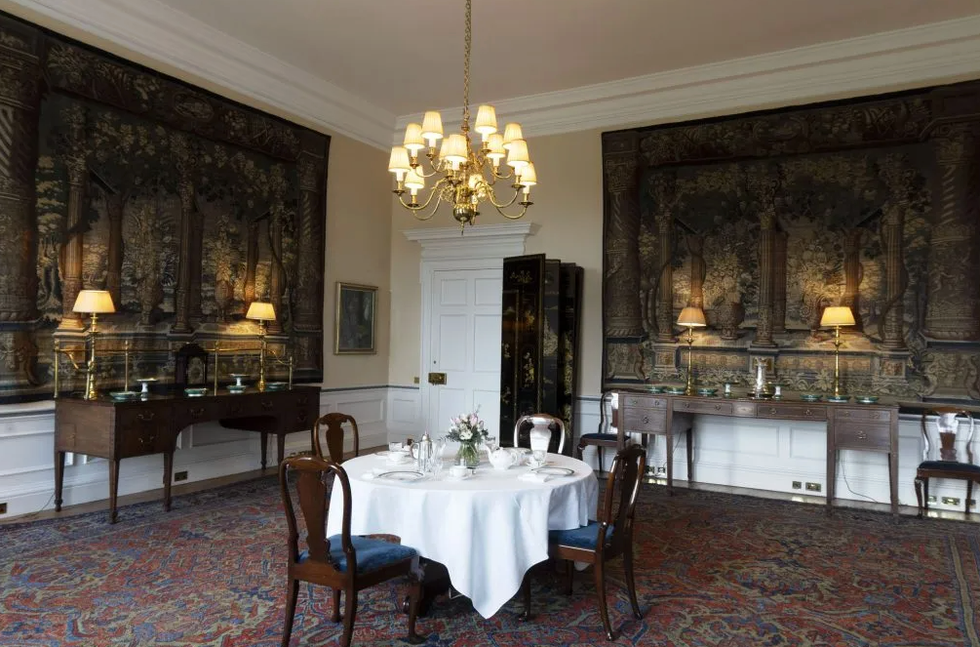 Elegant dining room with decorative walls and table set for a meal.