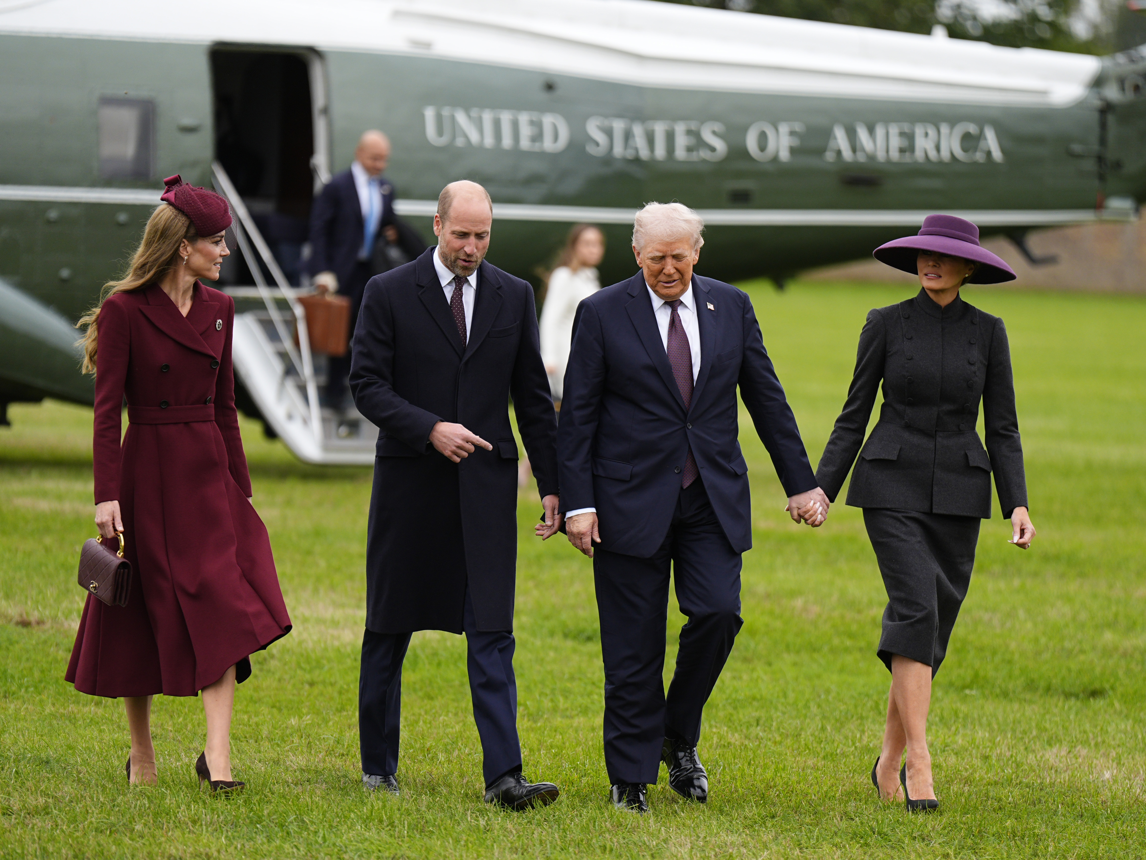 Princess Kate, Prince William, Donald Trump and Melania Trump walking in grass away from a plane