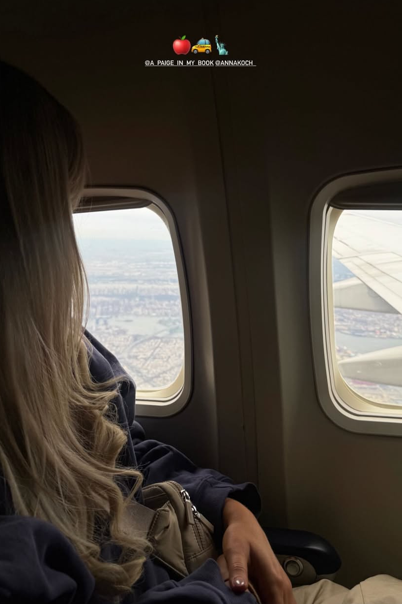 View from an airplane window with a passenger gazing outside.