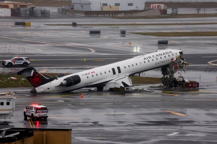 Emergency crews respond to an Air Canada Express plane on the tarmac after the plane collided with a fire truck at LaGuardia Airport (LGA) in the Queens borough of New York, US, on Monday, March 23, 2026. An Air Canada Express plane with 76 people aboard collided with a fire truck shortly after landing at New York's LaGuardia Airport late Sunday, killing the two pilots.