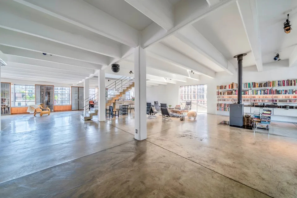 The chic industrial feel is completed by the floating staircase in the background. The Cote Team