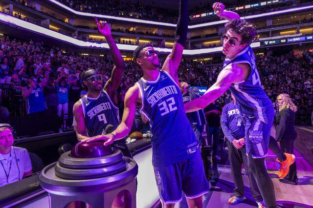 Sacramento Kings center Maxime Raynaud (42) jumps into the beam celebration with teammates  forward Precious Achiuwa (9) and center Dylan Cardwell (32) after their team’s 126-122 victory against the Brooklyn Nets at Golden 1 Center on Sunday, March 22, 2026. 
