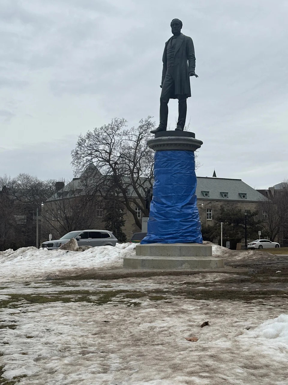 The George Brown monument at Queen's Park is wrapped by staff after it was vandalized during a protest on March 4. It took workers day to clean the statue. 