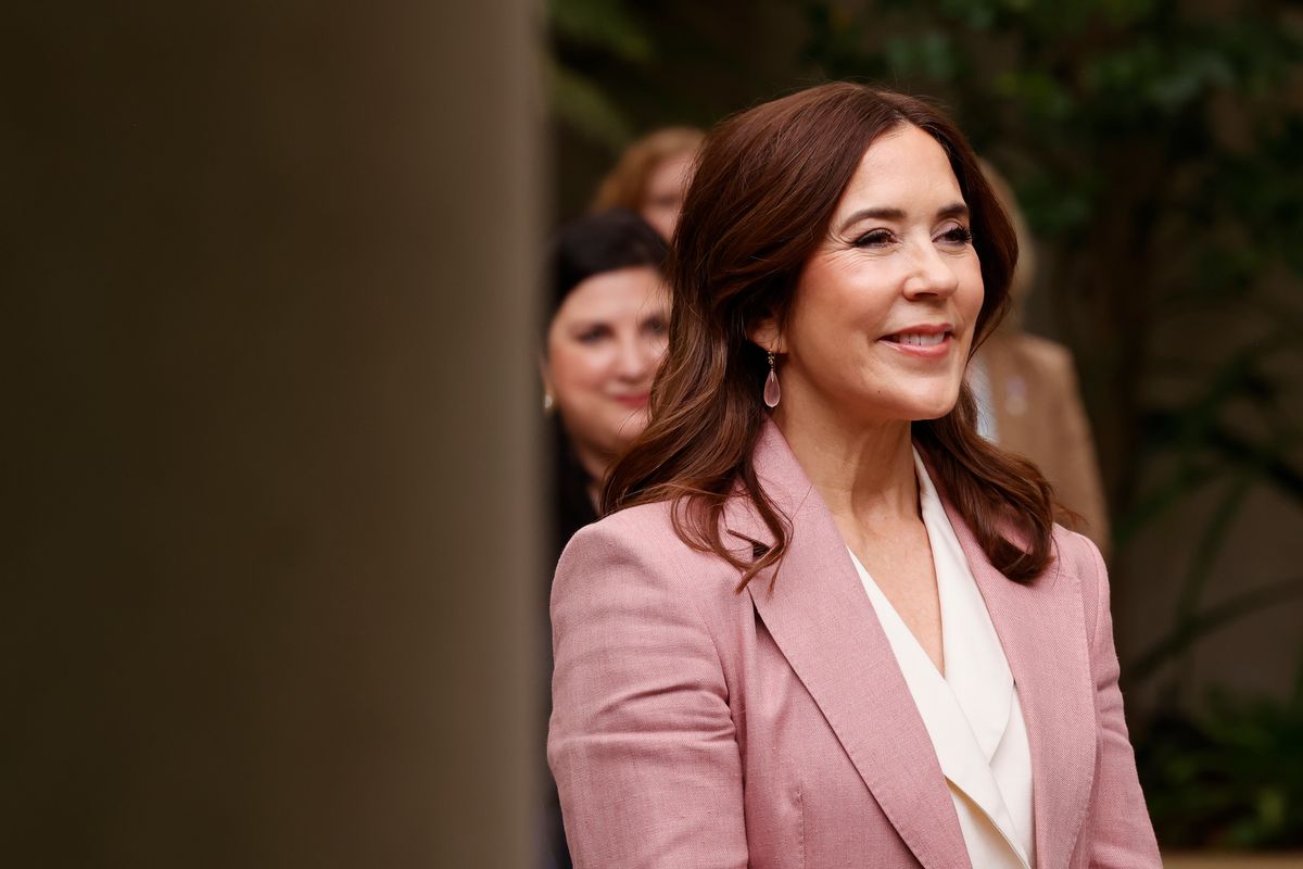 The queen selected a fitted pink blazer layered over a cream blouse designed with lapels and a waist-defining belt, paired with matching cream trousers.
