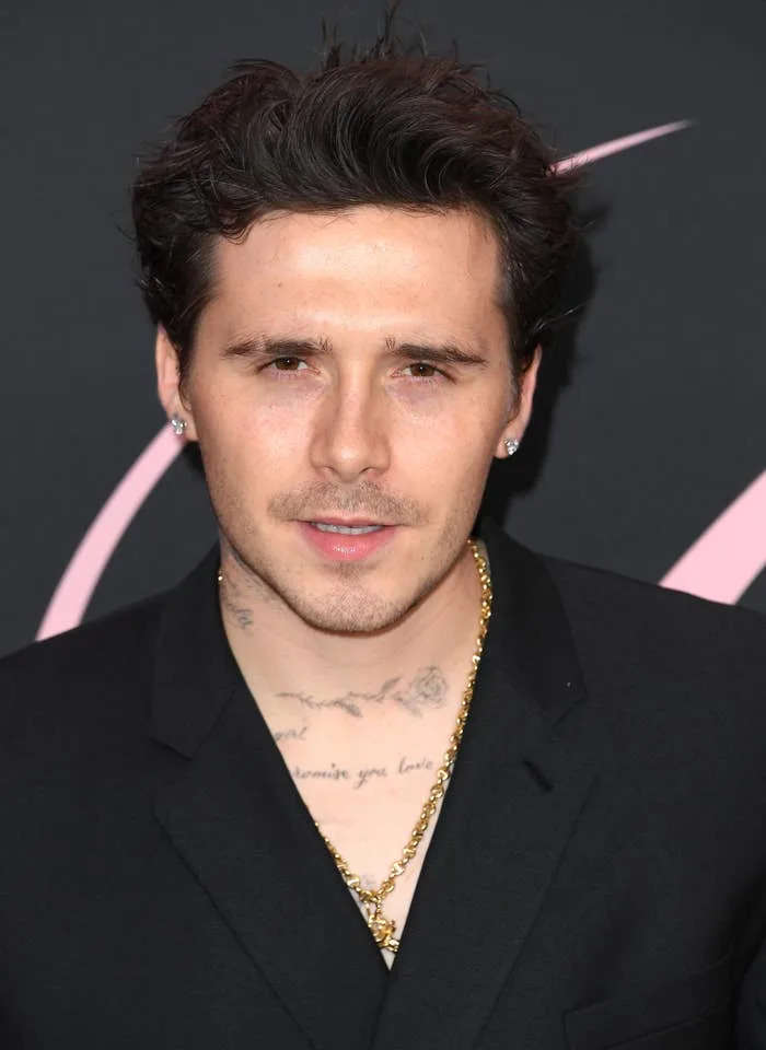 Brooklyn with short hair and a black suit jacket on a red carpet event