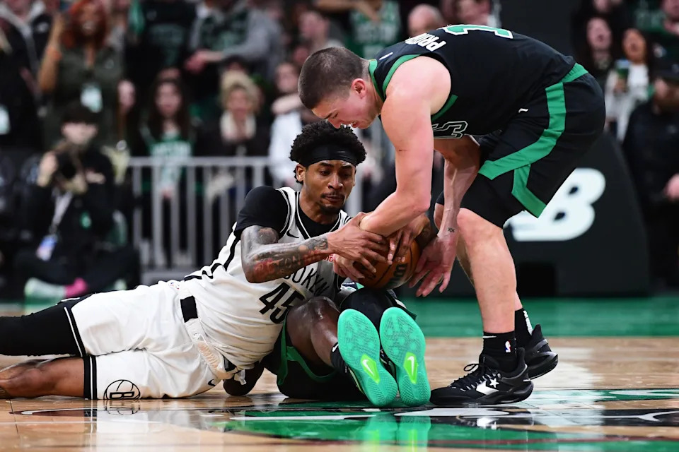 Mar 18, 2025; Boston, Massachusetts, USA; Brooklyn Nets guard Keon Johnson (45) and Boston Celtics guard Payton Pritchard (11) battle for the ball during the second half at TD Garden. Mandatory Credit: Bob DeChiara-Imagn Images