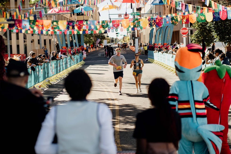 Runners participating in a race with a festive backdrop. Albuquerque Running Fiesta