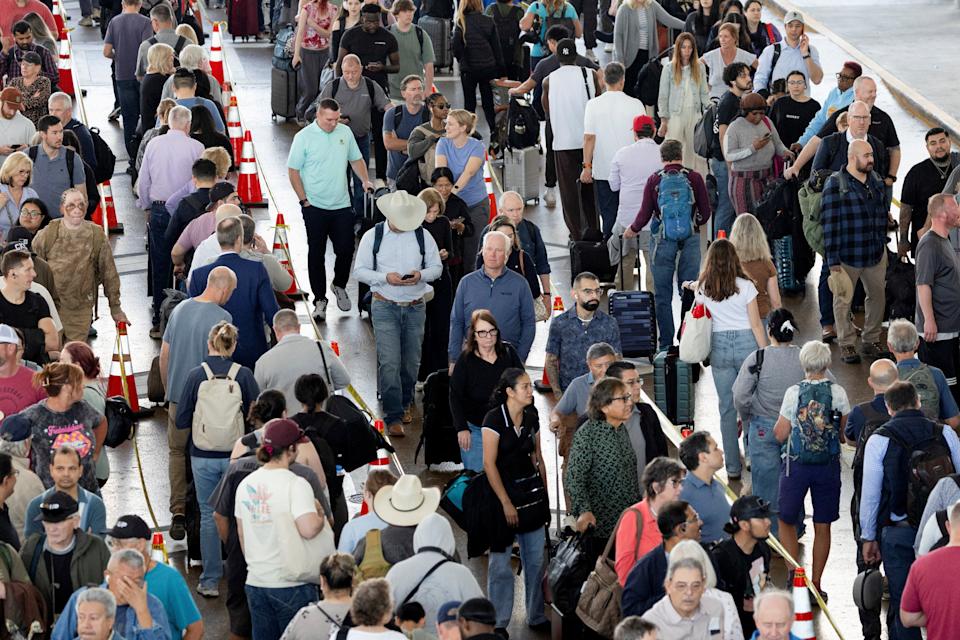 Passengers wait in long TSA lines amid a funding standoff that has forced 50,000 airport security officers to go without pay, causing delays at airports, at the George Bush Intercontinental Airport in Houston, Texas, U.S., March 25, 2026. REUTERS/Antranik Tavitian