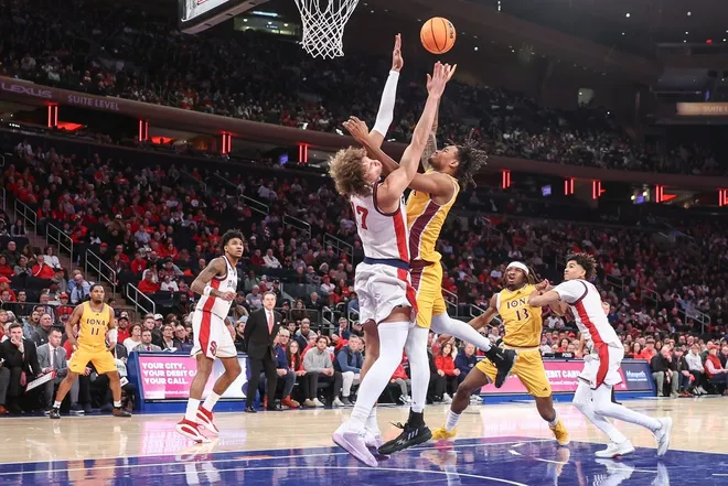 Dec 13, 2025; Queens, New York, USA; Iona Gaels forward Lamin Sabally (9) shoots over St. John's Red Storm forward Rubén Prey (17) in the first half at Madison Square Garden.
