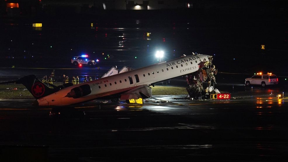 An Air Canada Jet sits on the runway at LaGuardia Airport, Monday, March 23, 2026, after colliding with a Port Authority aircraft rescue and firefighting vehicle in New York. (AP Photo/Ryan Murphy)