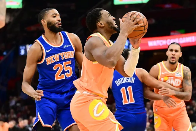 Feb 24, 2026; Cleveland, Ohio, USA; Cleveland Cavaliers guard Donovan Mitchell (45) drives to the basket against New York Knicks guard Mikal Bridges (25) during the second half at Rocket Arena.