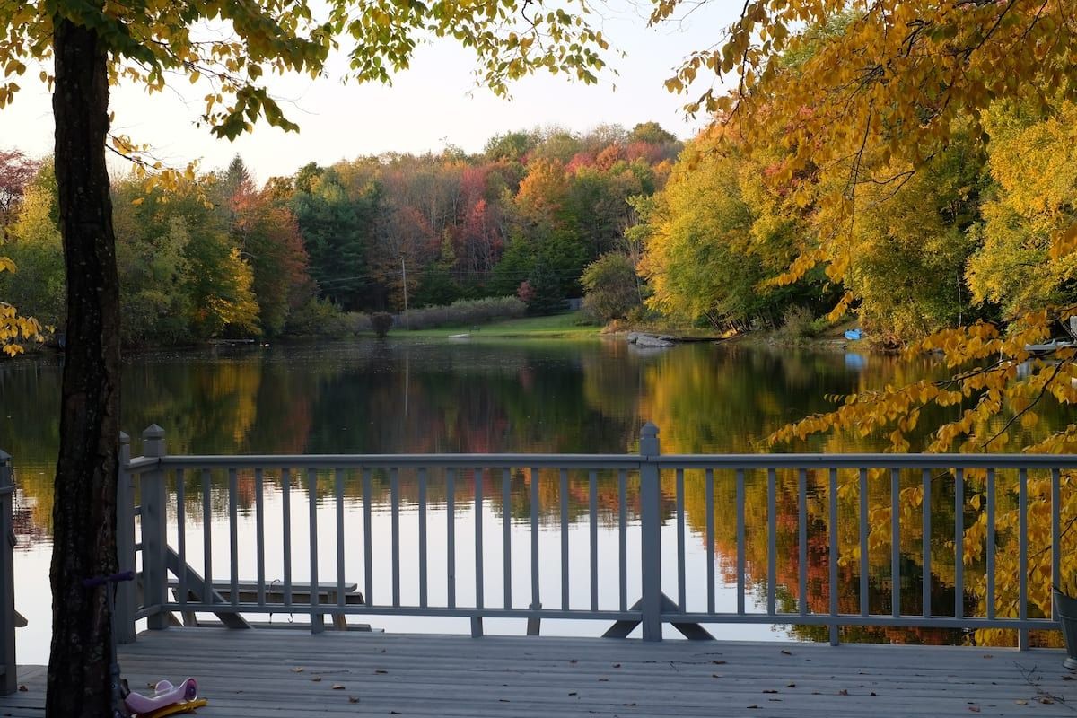 Image may contain Nature Outdoors Scenery Lakefront Bench Furniture Autumn Clothing Footwear and Shoe