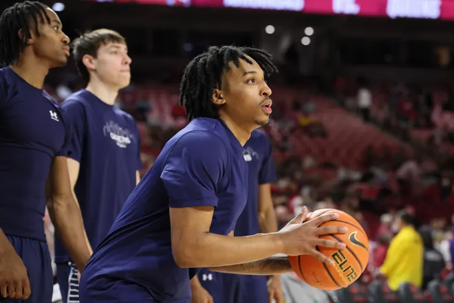 Queens Royals guard Chris Ashby warms up.