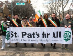 Marching behind the organization’s banner. Photos by Walter Karling