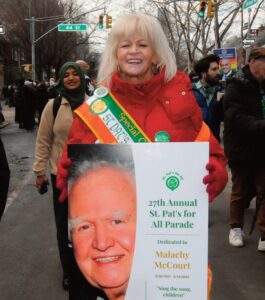 The parade was dedicated to the memory of the late renowned Irish-American luminary Malachy McCourt who participated in many previous parades. Seen carrying the placard is his daughter Siobhan McCourt.