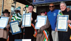 Commemorative plaques were presented to the three Grand Marshals (Ciarán O’Reilly, co-founder of the Irish Repertory Theatre; actor and author Kate Mul­grew; and Irish Repertory Theatre co-founder Charlotte Moore) and parade dignitaries by Queens Borough President Donovan Richards Jr. (2nd from right).