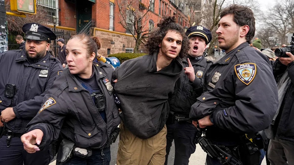 Police detain a man on a New York City street after he allegedly threw an explosive device during a protest.