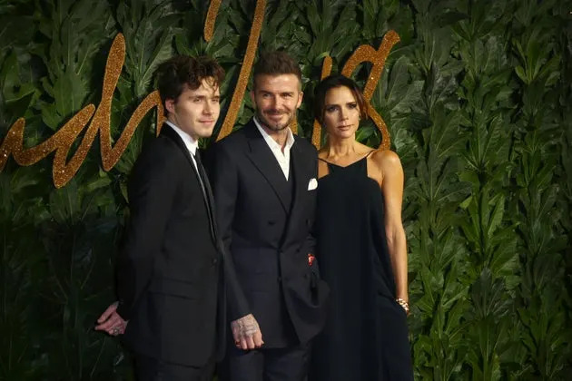 Brooklyn Peltz Beckham with his parents Sir David and Victoria Beckham in 2018